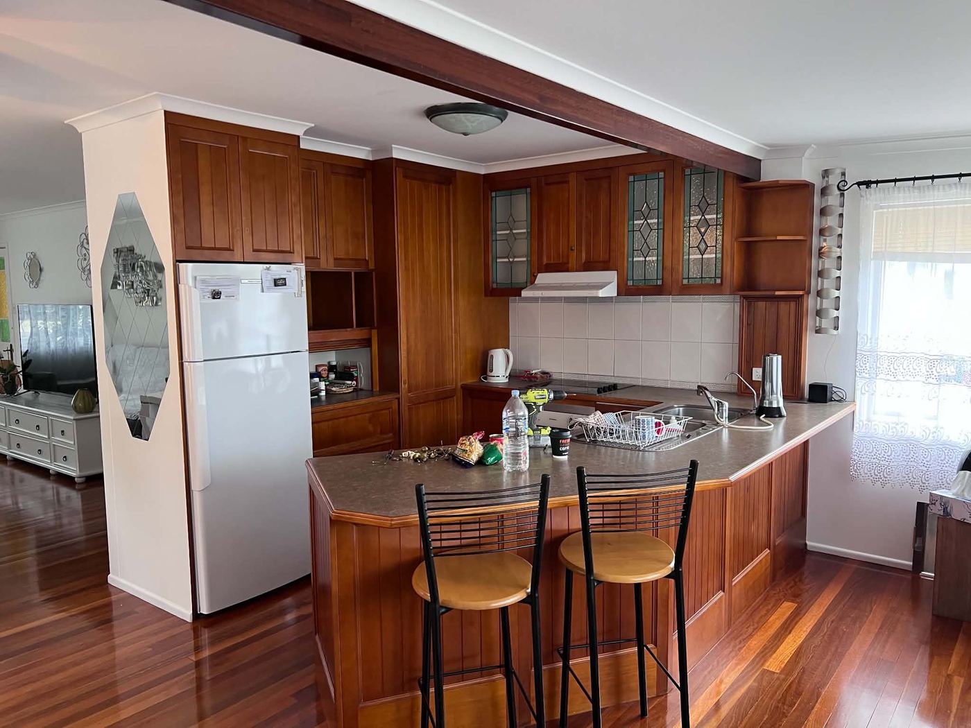 Dark timber kitchen before being repainted