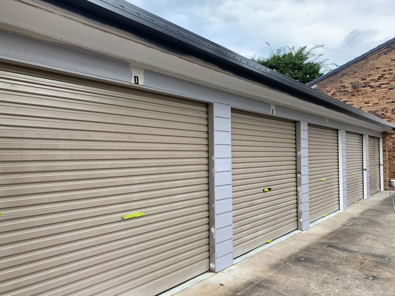Repainted strata complex roller doors in Brisbane